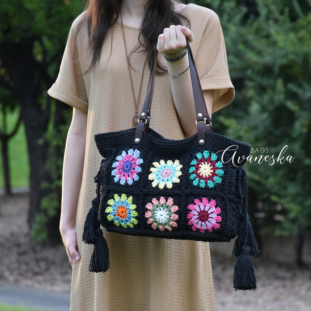 Handmade crochet granny square shoulder bag crafted from 100% cotton with vibrant colorful floral motifs.