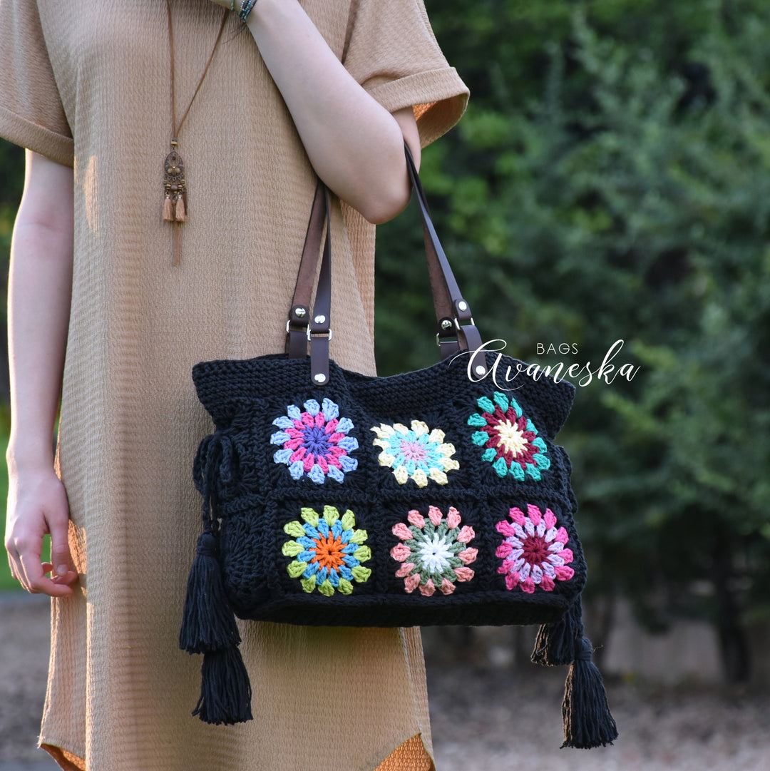 Handmade crochet granny square shoulder bag crafted from 100% cotton with vibrant colorful floral motifs.